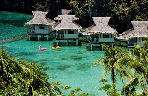 Thatched overwater villas at El Nido Resorts